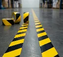 yellow-black-hazard-warning-floor-marking-tape-industrial-warehouse.webp